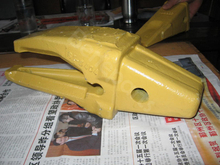 6I6404 Приварить зубья ковша задней скважины на переходник